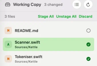 The working copy file list after staging a file: README.md marked M with an empty circle at the end of its row, Scanner.swift marked A with a green tick, and Tokeniser.swift marked M with a green tick — light appearance